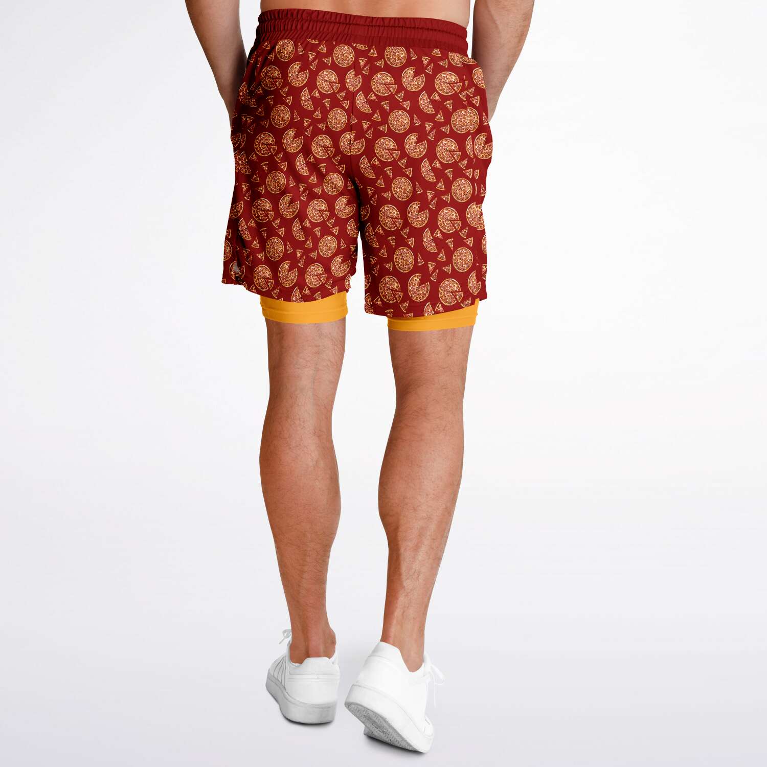 Men's shorts featuring a pizza design of pizza pies and pizza slices on a red background with an orange/yellow under short.