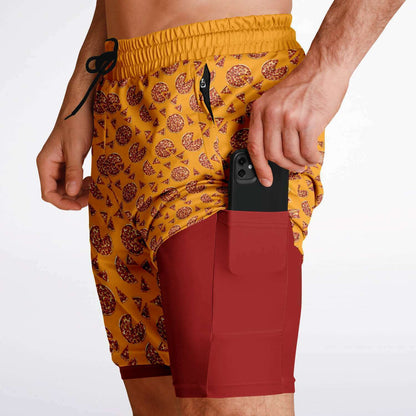 Men's shorts featuring a pizza design of pizza pies and pizza slices on a yellow background with a red under short.