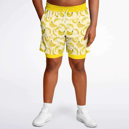 Men's 2-in-1 Shorts. These fun yellow workout shorts feature a banana design. Shorts have a drawstring, zip up side pockets, and hidden phone pocket.