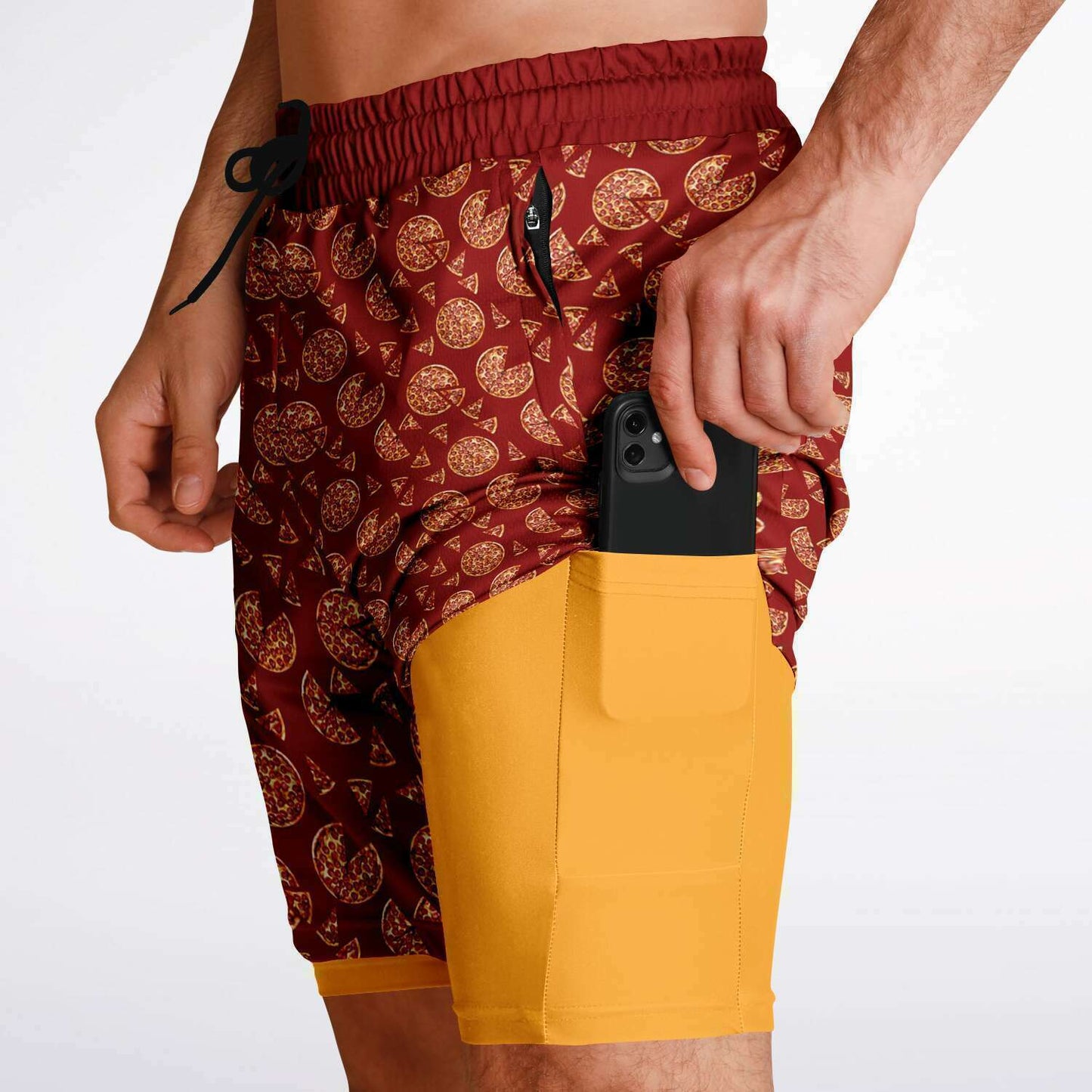 Men's shorts featuring a pizza design of pizza pies and pizza slices on a red background with an orange/yellow under short.