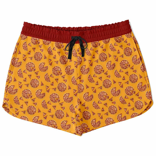 Women’s shorts featuring a pizza design of pizza pies and pizza slices on a yellow background with a red waistband and red outer pocket with a slice of pizza.