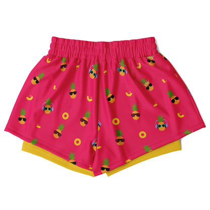 Women's 2-in-1 Shorts. These fun shorts feature a pink background with pineapples wearing a variety of sunglasses, and a yellow under-short with a hidden phone pocket.