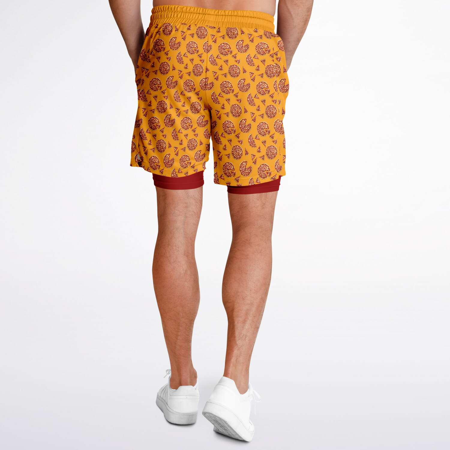 Men's shorts featuring a pizza design of pizza pies and pizza slices on a yellow background with a red under short.