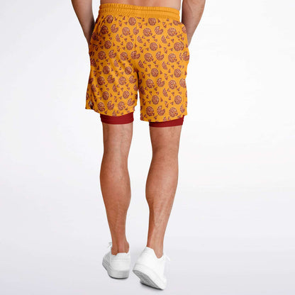 Men's shorts featuring a pizza design of pizza pies and pizza slices on a yellow background with a red under short.