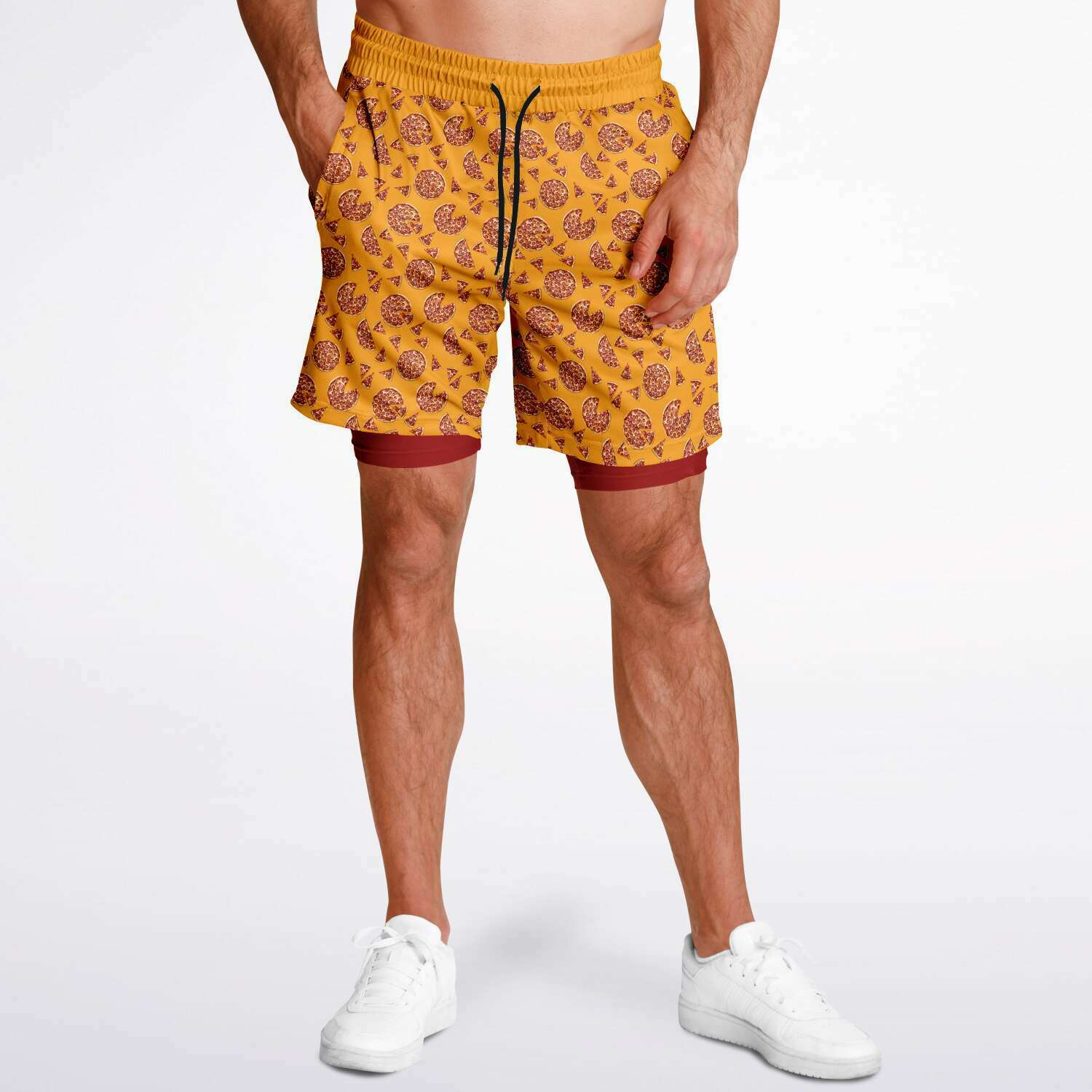 Men's shorts featuring a pizza design of pizza pies and pizza slices on a yellow background with a red under short.