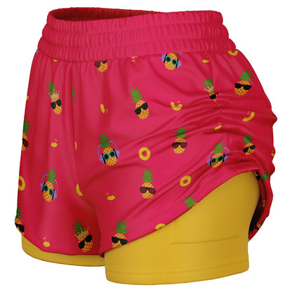 Women's 2-in-1 Shorts. These fun shorts feature a pink background with pineapples wearing a variety of sunglasses, and a yellow under-short with a hidden phone pocket.